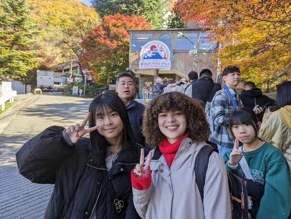 Students at the Mt. Fuji Panoramic Ropeway amid autumn leaves