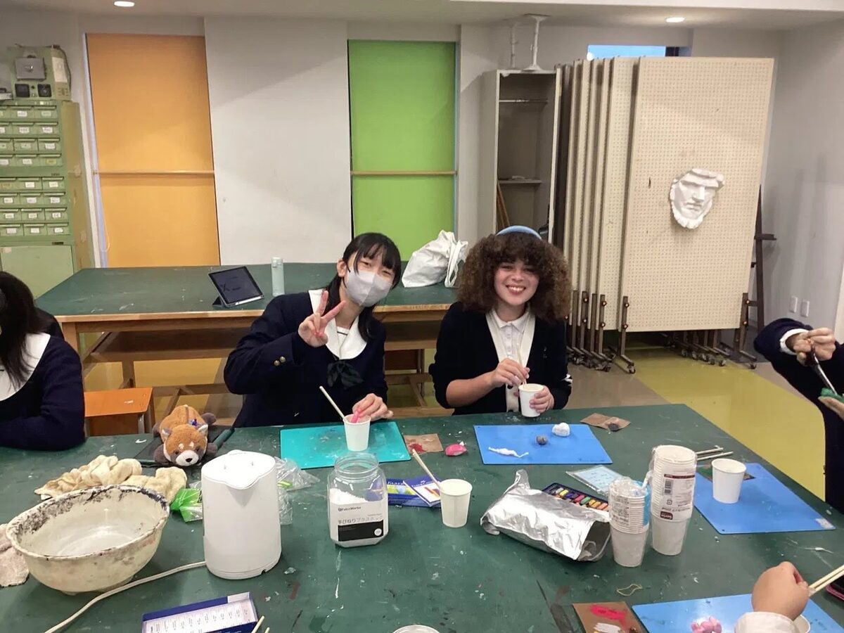 Students and their Japanese buddies in an art workshop